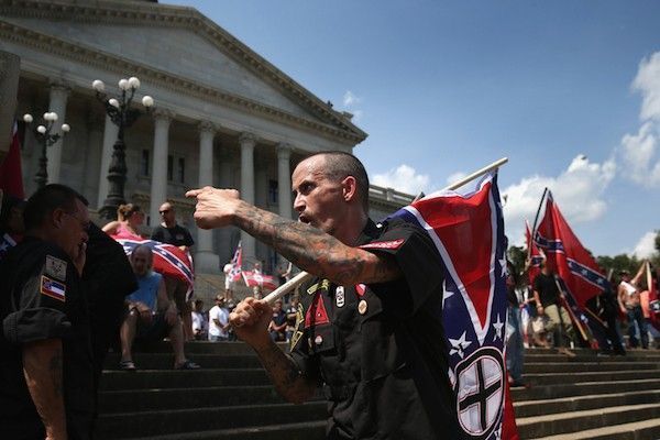 COLUMBIA, SC - JULY 18: Counter protesters and Ku Klux Klan members argue at a Klan demonstration at the state house building on July 18, 2015 in Columbia, South Carolina. The KKK protested the removal of the Confederate flag from the state house grounds and hurled racial slurs at minorities as law enforcement tried to prevent violence between the opposing groups. John Moore/Getty Images/AFP