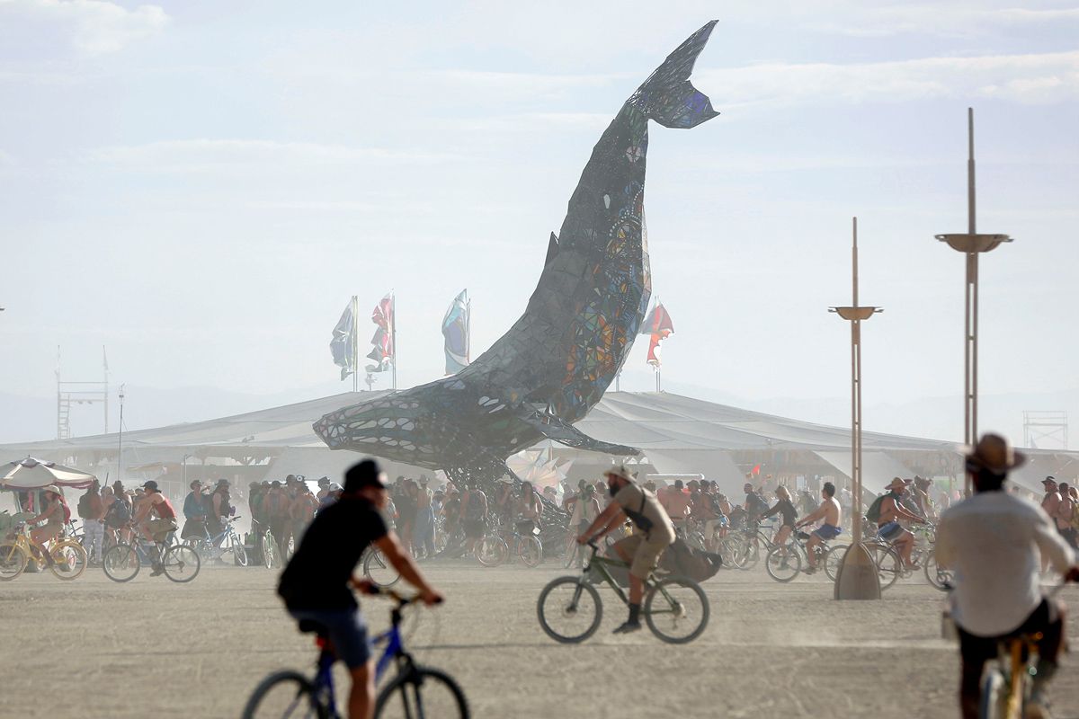 Participants gather around The Space Whale art installation as approximately 70,000 people from all over the world gather for the 30th annual Burning Man arts and music festival in the Black Rock Desert of Nevada, U.S. August 29, 2016. Picture taken August 29, 2016. REUTERS/Jim Urquhart FOR USE WITH BURNING MAN RELATED REPORTING ONLY. FOR EDITORIAL USE ONLY. NO RESALES. NO ARCHIVES. NOT FOR SALE FOR MARKETING OR ADVERTISING CAMPAIGNS. NO THIRD PARTY SALES. NOT FOR USE BY REUTERS THIRD PARTY DISTRIBUTORS - RTX2NK48